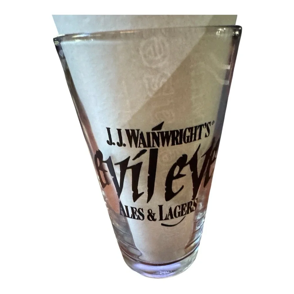JJ Wainwrights Evil Eye Ales & Lagers Beer Pint Glass Vintage Black Logo Barware